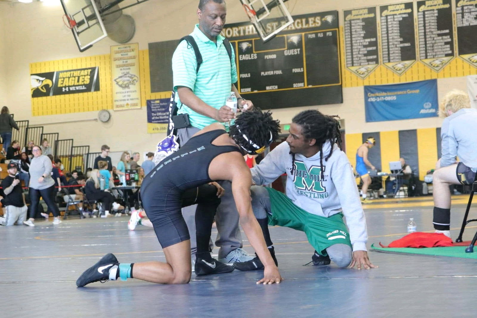 Coach coaching a wrestler mat-side at a Baltimore tournament