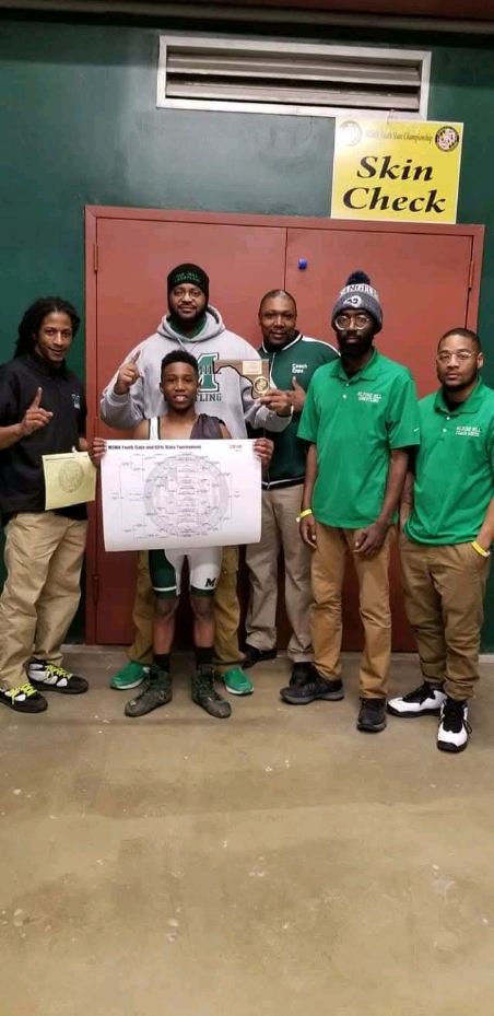 Coaches and a state placer with the bracket sheet